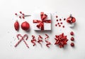 Christmas decoration, gift boxes with red ribbon, sparkles, confetti, christmas candy and balls on white background. Xmas Royalty Free Stock Photo