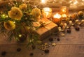 Christmas decoration. Gift, candles, lights, golden balls on a wooden rustic table. Composition of pine branches and Royalty Free Stock Photo