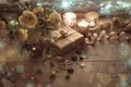 Christmas decoration. Gift, candles, lights, golden balls on a wooden rustic table. Composition of pine branches and Royalty Free Stock Photo