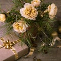 Christmas decoration. Gift, candles, lights, golden balls on a wooden rustic table. Composition of pine branches and Royalty Free Stock Photo