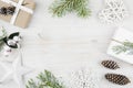 Christmas decoration, gift, frosted cypress branches, pine cones. Wooden background