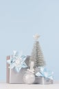 Christmas decoration and gifts in soft blue color - different metallic boxes with ribbons and bows, silver tree, glitter ball. Royalty Free Stock Photo