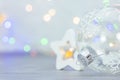 Christmas decoration with glass ball on blurred background with colorful lights Royalty Free Stock Photo