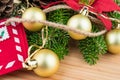 Christmas decoration - golden baubles, poinsettia, fir branches and cones Royalty Free Stock Photo