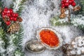 Christmas Decoration greeting card- Red caviar in silver bowl, Snowy Pine Cones On Fir Branch With Christmas Lights Royalty Free Stock Photo