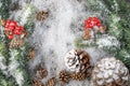 Christmas Decoration greeting card- Snowy Pine Cones On Fir Branch With Christmas Lights Royalty Free Stock Photo