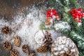 Christmas Decoration greeting card- Snowy Pine Cones On Fir Branch With Christmas Lights Royalty Free Stock Photo