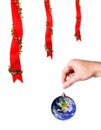 Christmas decoration and hand holding earth