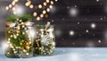 Christmas decoration handmade in glass jar with lights, fir tree, pine cones. Christmas still life on black wooden background, Royalty Free Stock Photo