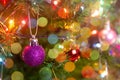 Christmas decoration. Hanging purple balls on pine branches christmas tree garland and ornaments over abstract bokeh background Royalty Free Stock Photo