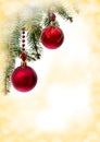 Christmas decoration. Hanging red balls on abstract golden background with space for text Royalty Free Stock Photo