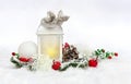 Christmas decoration. Christmas lantern, white openwork flowers poinsettia, white balls, cones, red apples, berries Royalty Free Stock Photo