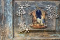 Christmas decoration: Nativity scene image and Wooden snowflakes laid on an old wooden surface. Top view. Copy space Royalty Free Stock Photo