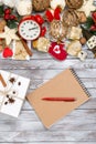 Christmas decoration, notebook and pen over wooden background. Winter holidays concept. Space for text. Royalty Free Stock Photo