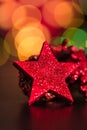 Christmas decoration and ornaments. Christmas composition on blurred lights background. Red and glittery decorations