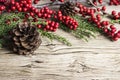 Christmas decoration of pine cone and red winterberry Royalty Free Stock Photo