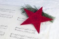 Christmas decoration with pine tree, red star and musical score Royalty Free Stock Photo