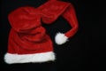 Christmas decoration with place for greeting on chalk blackboard. Santa Claus hat and gift boxes