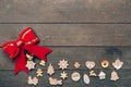 christmas decoration and red bow on wood background with copyspace. Royalty Free Stock Photo