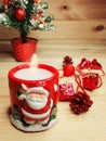 Christmas decoration red candle with santa composition on wooden Royalty Free Stock Photo