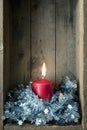 Christmas decoration red candle in a wooden box background Royalty Free Stock Photo