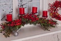 Christmas decoration with red candles, berries, garland lights and pine branch Royalty Free Stock Photo