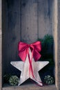 Christmas decoration red ribbon on a star in a wooden box background Royalty Free Stock Photo