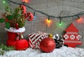 Christmas decoration:red Santa`s boot,fir tree,garland,gift,pine cone and toys on wooden background.Christmas background.