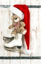 Christmas decoration. Red Santas hat, Teddy Bear, ice skates Royalty Free Stock Photo