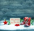 Christmas decoration red stars and antique baby shoes in snow Royalty Free Stock Photo