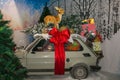 Christmas decoration, reindeer and gift over the car at the interior of shop in Sant`Elpidio a Mare