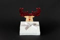 Christmas decoration reindeer with silver gift box on a black ba Royalty Free Stock Photo