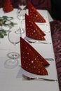 Christmas decoration on a restaurant table. wine glass, red napkins; Royalty Free Stock Photo