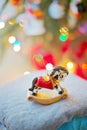 Christmas decoration rocking horse in front of the Christmas tree