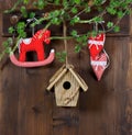 christmas decoration. rocking horse and red hearts on wooden background