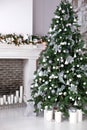 Christmas decoration of room, Christmas tree decorations, toys, garlands, fireplace with candles. New Year interior of living room Royalty Free Stock Photo