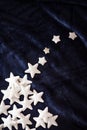 Christmas decoration on royal blue background. Top view on stars wings and ornaments.