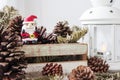 Christmas decoration of santa claus and pine cones on wooden cab Royalty Free Stock Photo