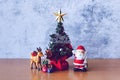 Christmas decoration - Santa Clause, tree and gift on wooden table. Christmas and Happy new year concept Royalty Free Stock Photo