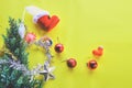 Christmas decoration. Santa`s boot,red ball, fir tree branches with cones and christmas toys on yellow background. Top view Royalty Free Stock Photo