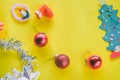 Christmas decoration. Santa`s boot,red ball, fir tree branches with cones and christmas toys on yellow background. Top view Royalty Free Stock Photo