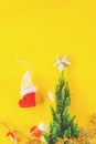 Christmas decoration. Santa`s boot,red ball, fir tree branches with cones and christmas toys on yellow background. Top view Royalty Free Stock Photo