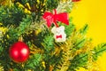 Christmas decoration. Santa`s boot,red ball, fir tree branches with cones and christmas toys on yellow background. Top view Royalty Free Stock Photo