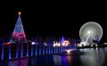 Christmas decoration set consisting of a Christmas tree, water with lights and a giant Ferris wheel.