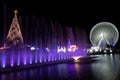 Christmas decoration set consisting of a Christmas tree, water with lights and a giant Ferris wheel.