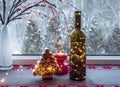 Christmas decoration set with wine bottle filled with micro led party lights and spruce tree made with used wine corks. Royalty Free Stock Photo