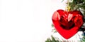 Christmas decoration in the shape of a heart on a tree. Copy space