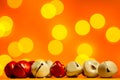 Christmas decoration - little jingle bells on red background with plenty copy space and lights Royalty Free Stock Photo