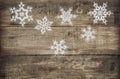Christmas decoration snowflakes on rustic wooden background Royalty Free Stock Photo