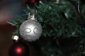 Christmas Decoration with Solver and Red Baubles into Fluffy Green Pine Branches closeup. Selective focus